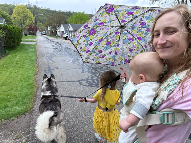 Mom walking with kids and dog in rain