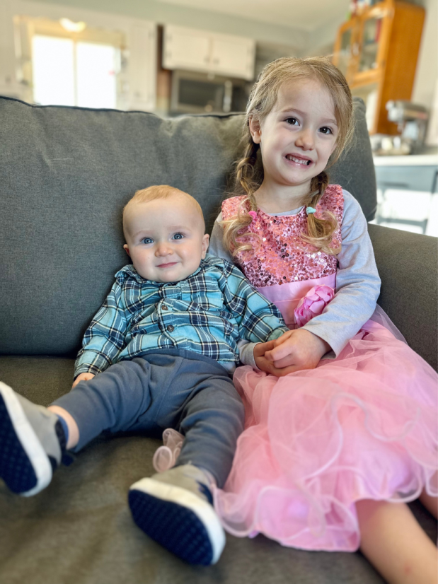 Brother and sister smiling on couch together