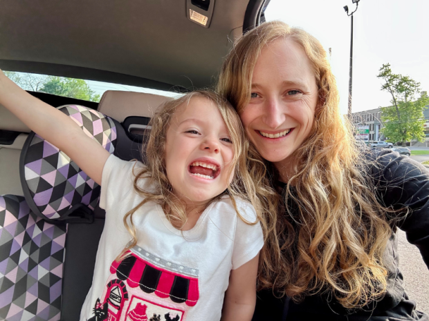 Mom and daughter in car smiling