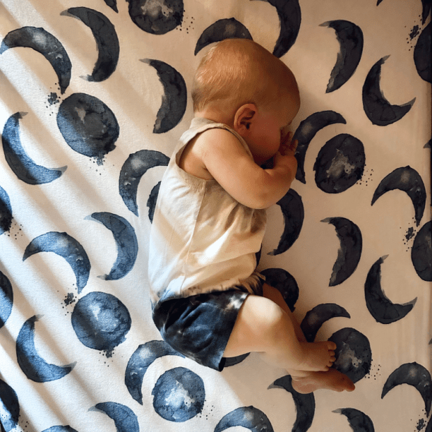 Six month old baby boy sleeping on side