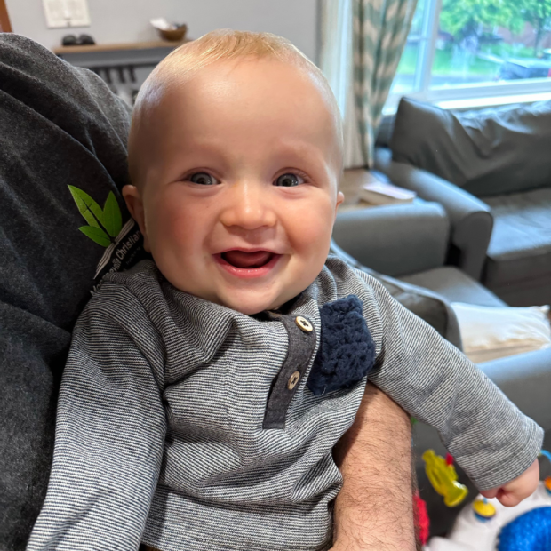 Six month old baby boy smiling