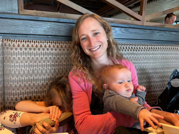 Mom holding baby and while at Firebirds restaurant