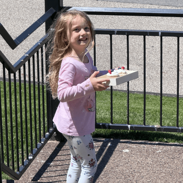 Girl holding cupcakes