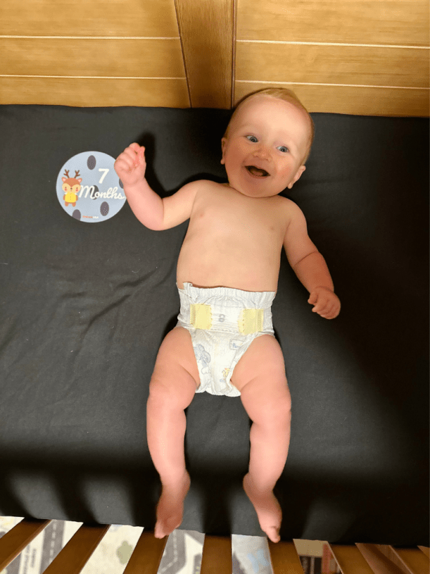 Seven month old baby boy in crib