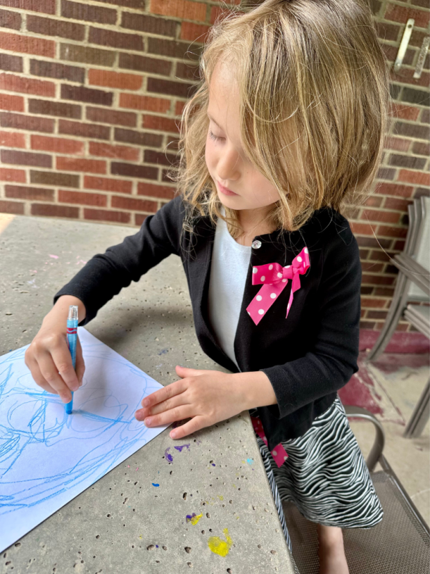 Girl coloring outside