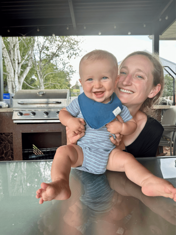 Mom holding baby boy on table