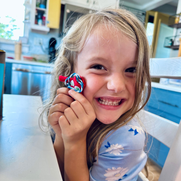 Girl holding a homemade stuffed doll