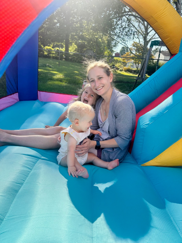 Mom with baby and daughter in bounce house