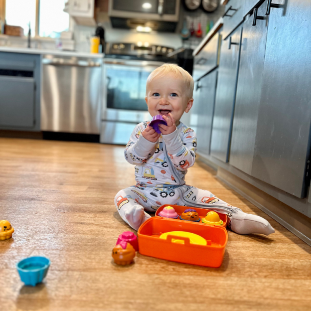 Baby boy playing with toy cupcakes
