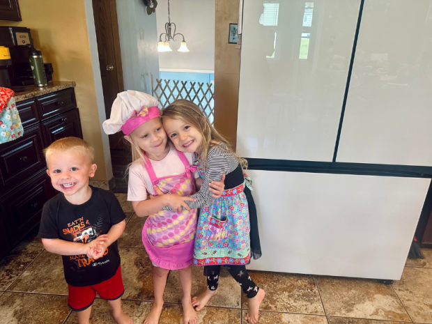 Kid cousins standing in kitchen together