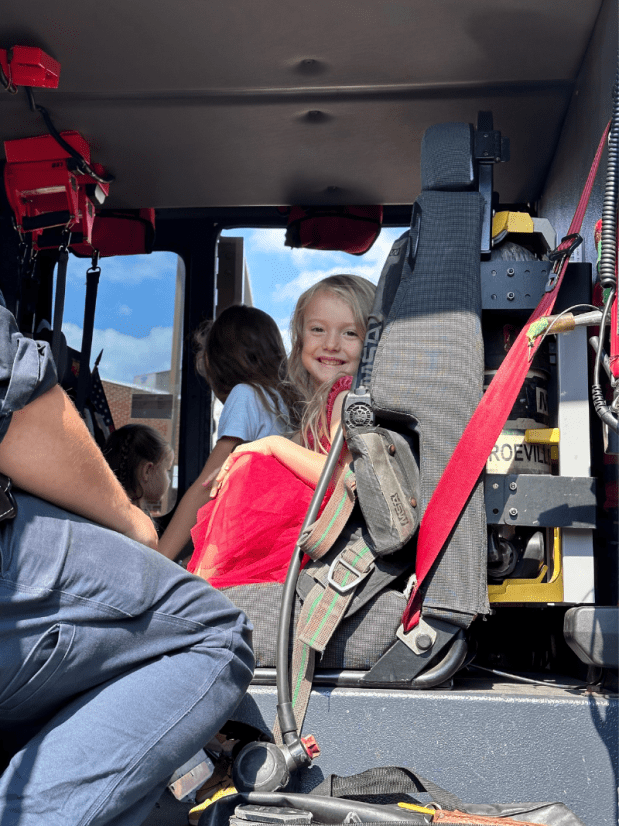 Young girl sitting in a fire truck
