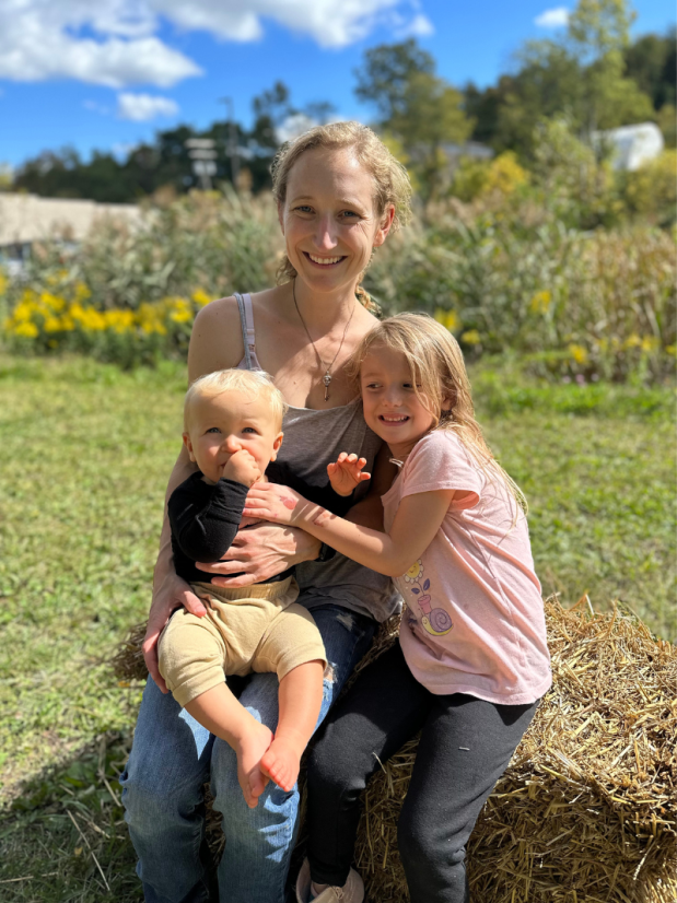 Mom holding baby and sitting with five year old