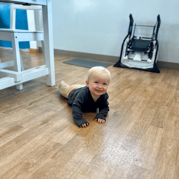 Baby boy crawling on floor
