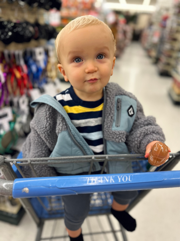 Baby boy sitting in cart in Hobby Lobby
