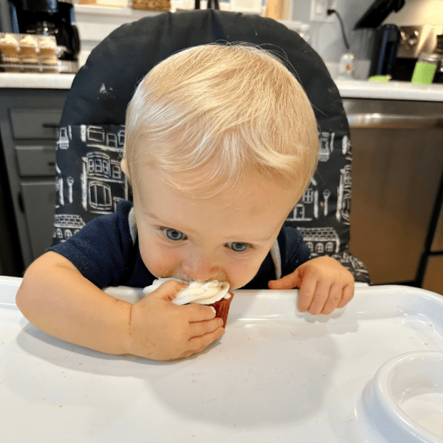 Baby boy eating a cupcake