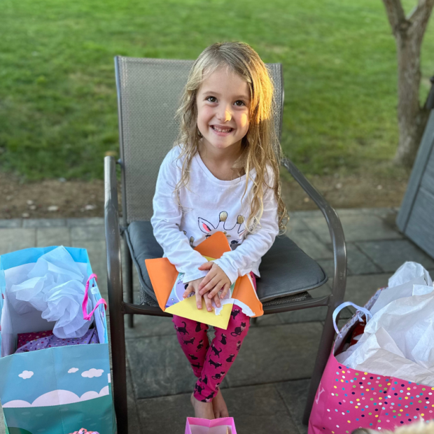 Girl opening birthday cards and gifts