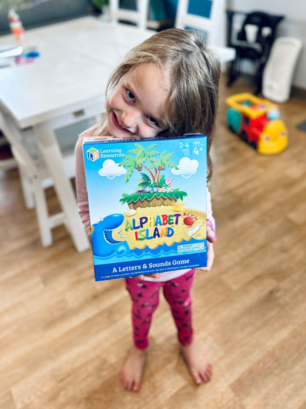 Girl holding Alphabet Island game