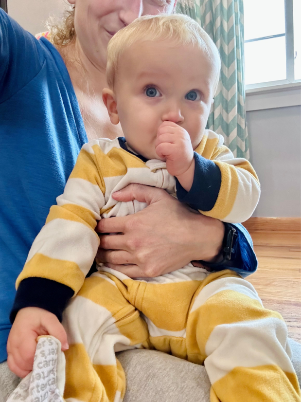 One year old baby boy sucking his thumb