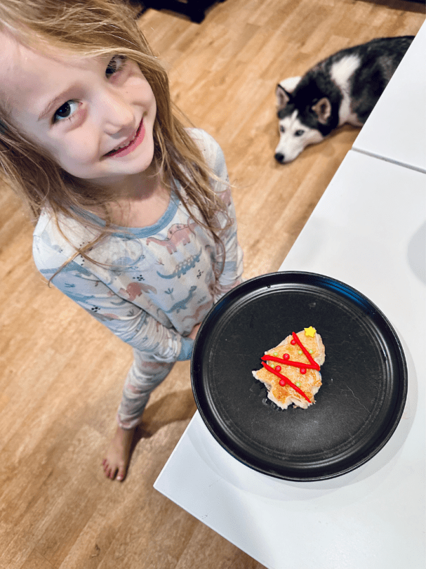 Girl standing by Christmas tree pancake