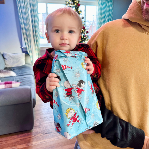 Baby boy holding Christmas gift