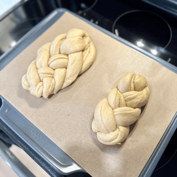 Peanut butter and honey challah rising on cookie sheet