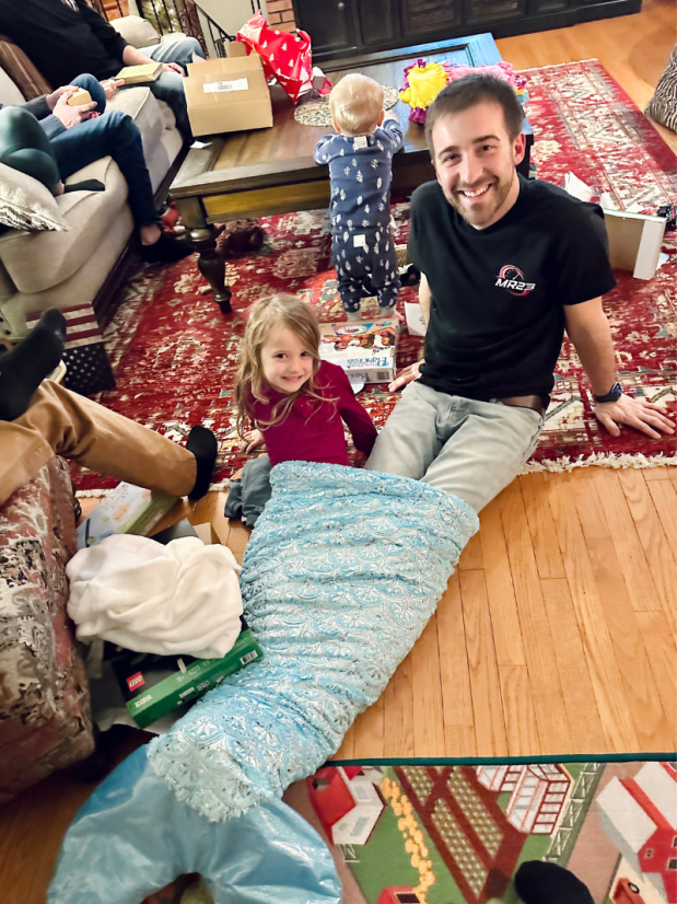 Dad and daughter in mermaid tail blanket