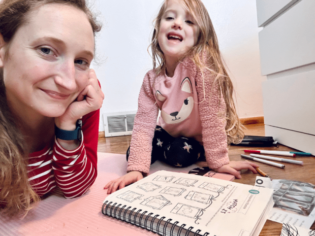 Mom and daughter homeschooling on the floor