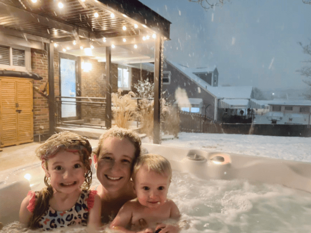 Mom and kids in hot tub in snow