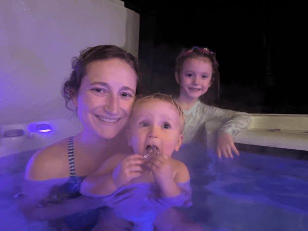 Mom in hot tub with girl and baby boy