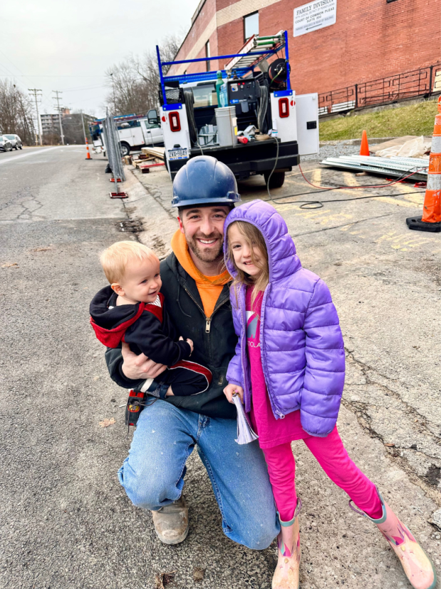 Dad on job site with daughter and baby boy