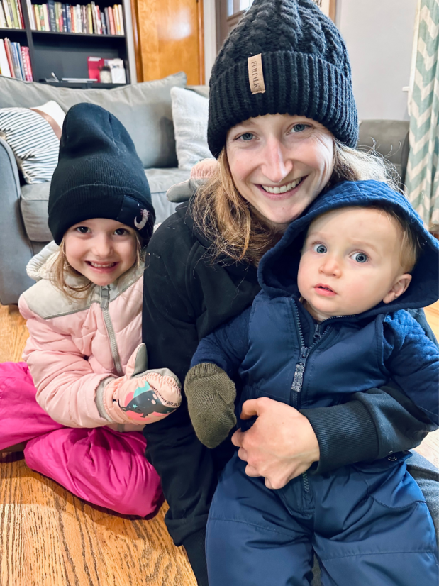 Mom holding kids ready to play in snow