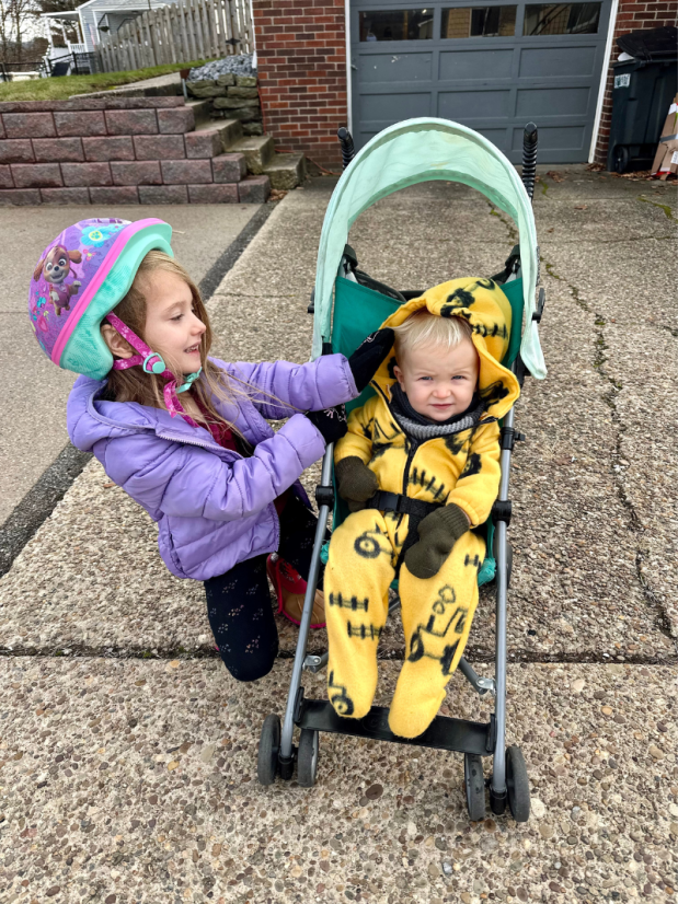 Girl and baby brother outside