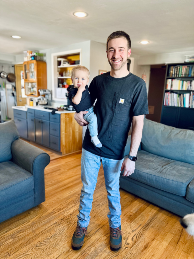 Dad and baby boy wearing matching black shirts and light denim jeans