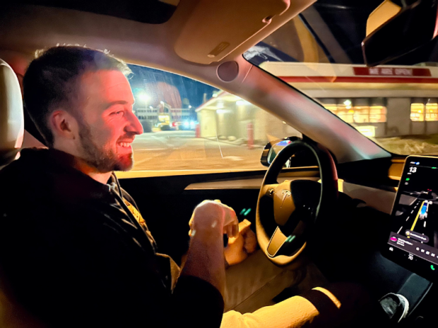 Guy in a Tesla Model Y with self driving mode on