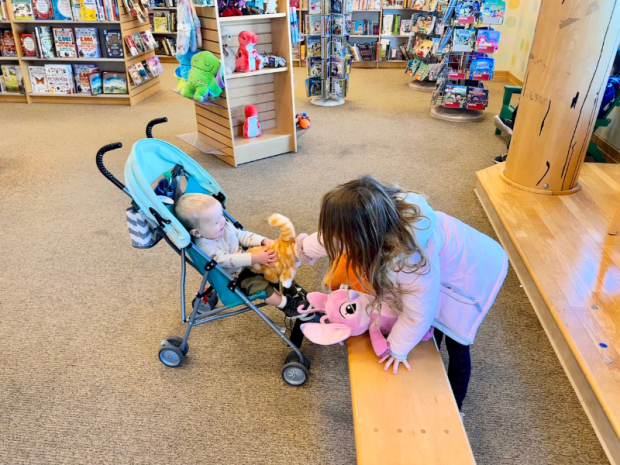 Brother and sister playing with puppets at Barnes and Noble