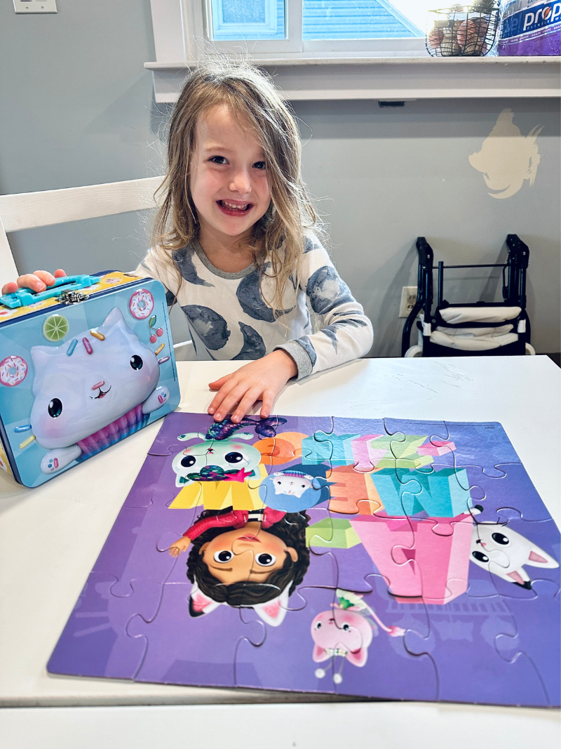 Girl with Gabby's Doll House puzzle