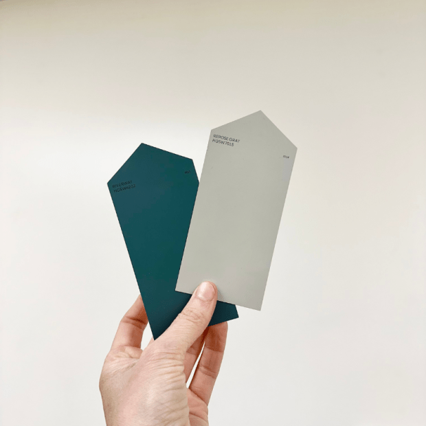 Paint chips in a hand against a wall