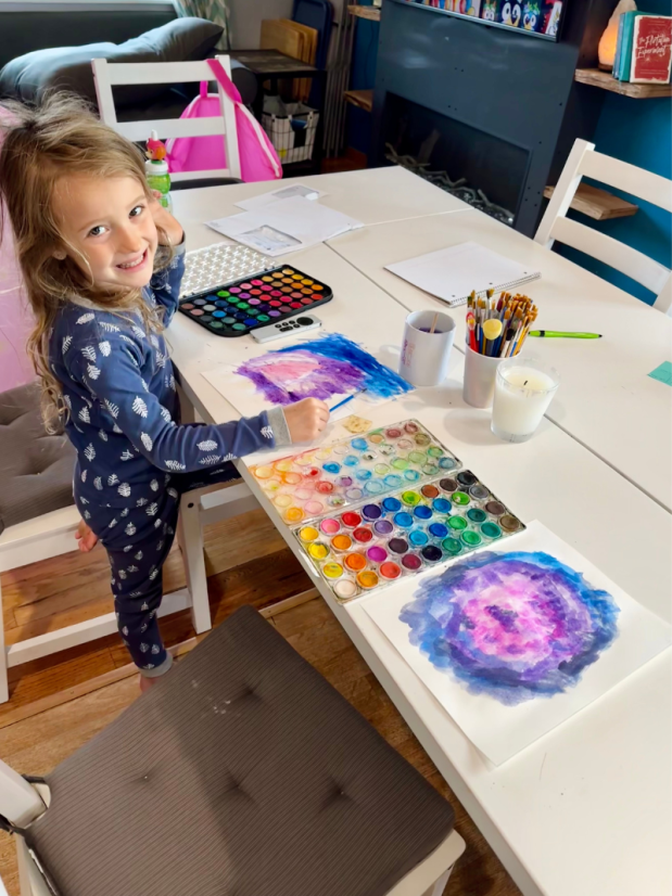 Girl watercoloring at kitchen table