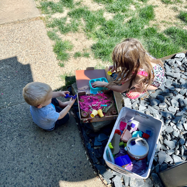 Kids playing with kinetic sand outside