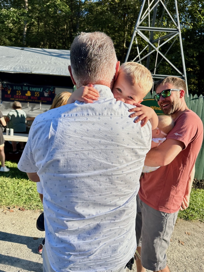 Grandpa hugging toddler grandson