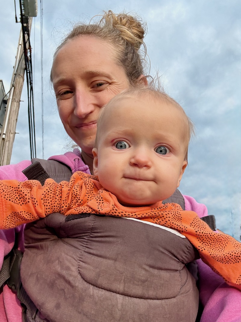 Mom with baby in baby carrier selfie