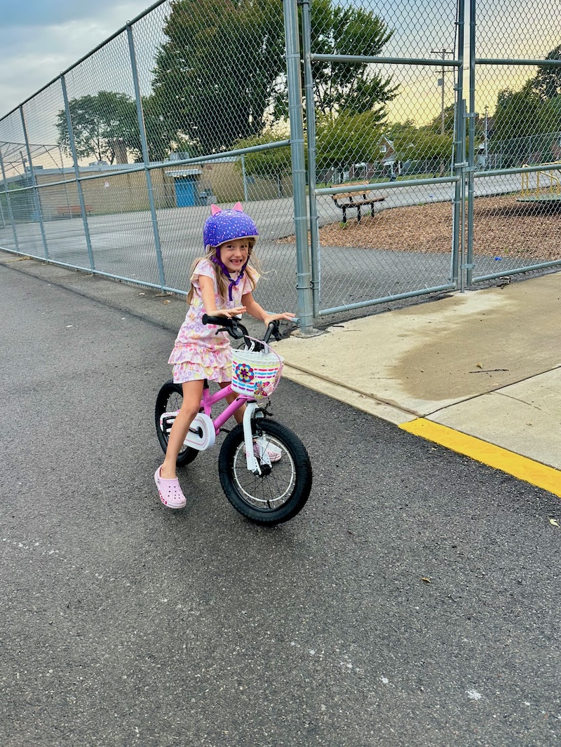 Young girl riding bike outside