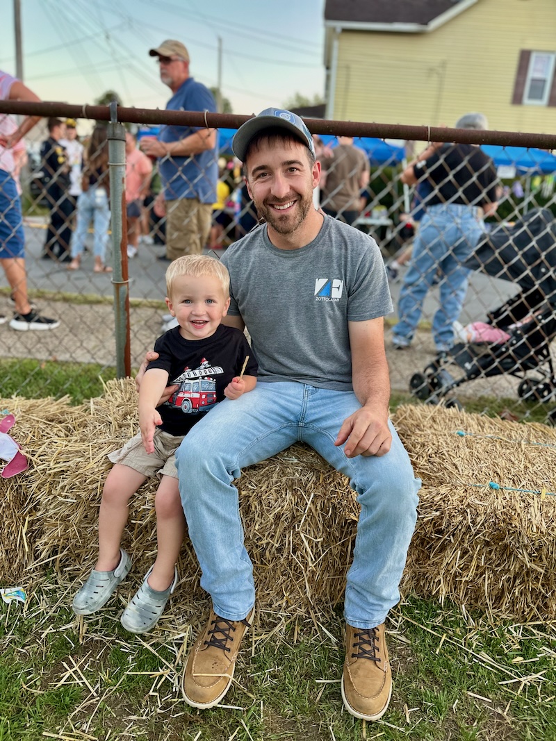 Father and son on a hay bale