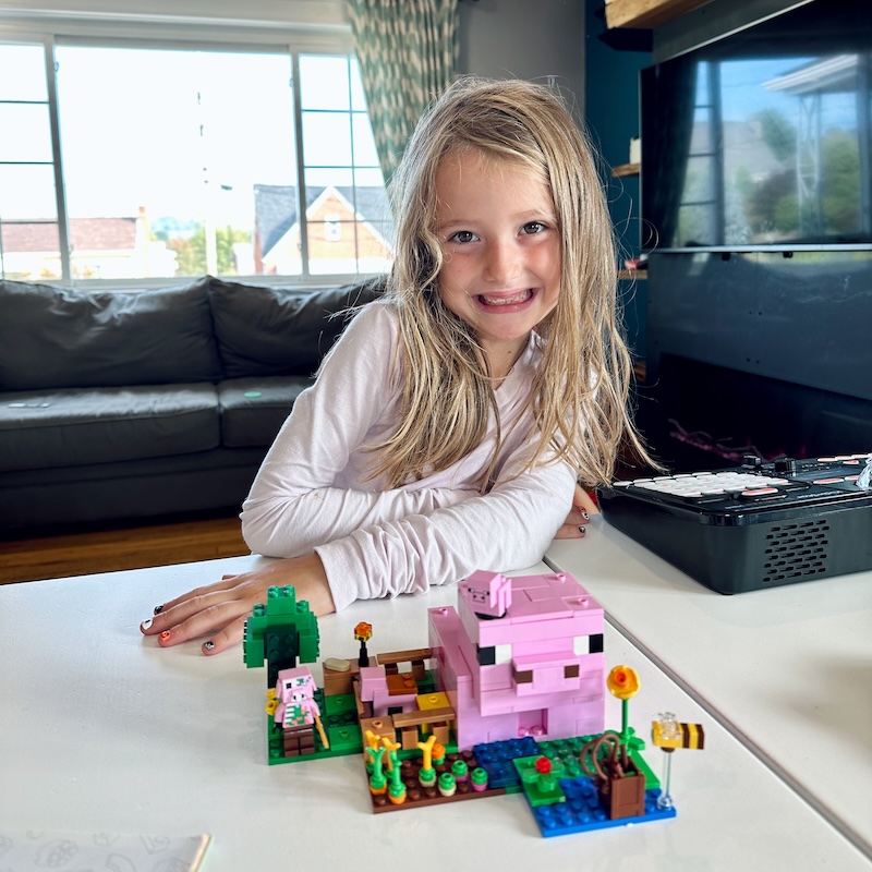 Girl with Minecraft Pig House Lego set