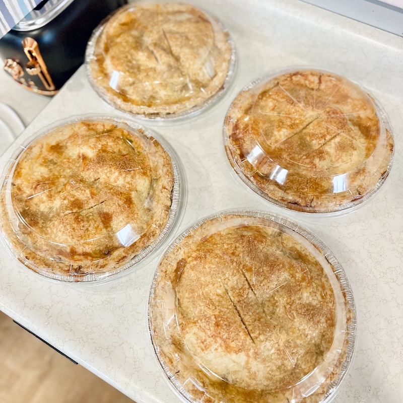 Four apple pies on counter