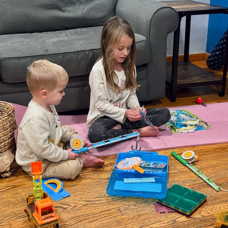 Girl and toddler boy playing with Melissa and Doug fishing toy