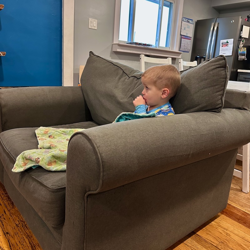 Toddler boy sitting on couch