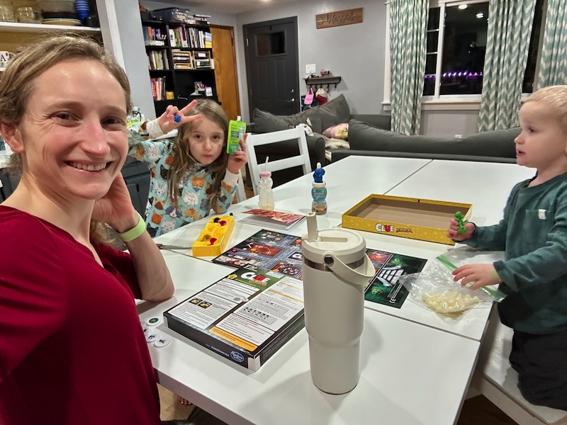 Mom and kids playing Clue board game