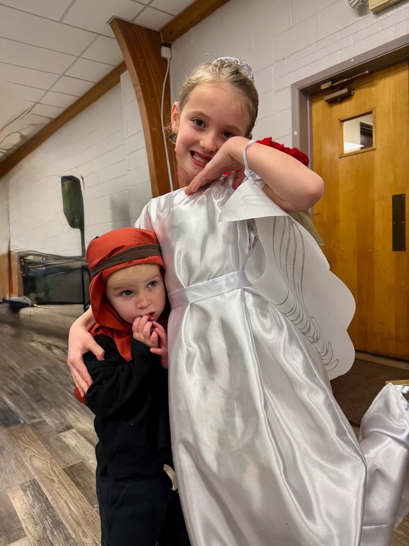 Brother and sister dressed as angel and shepherd