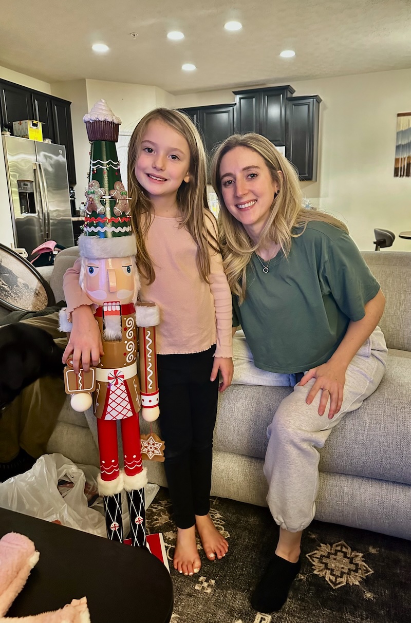 Girls sitting by nutcracker